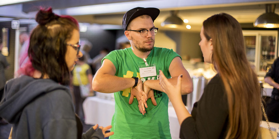 Two people are deep in discussion at a creative event.