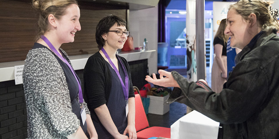 Two people are deep in discussion at an event.