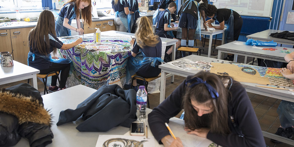 A group of students working in an art room.