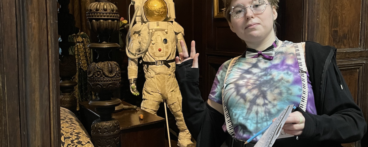 Libby is stood in a heritage venue. She is looking directly at the camera.
