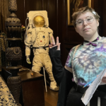 Libby is stood in a heritage venue. She is looking directly at the camera.