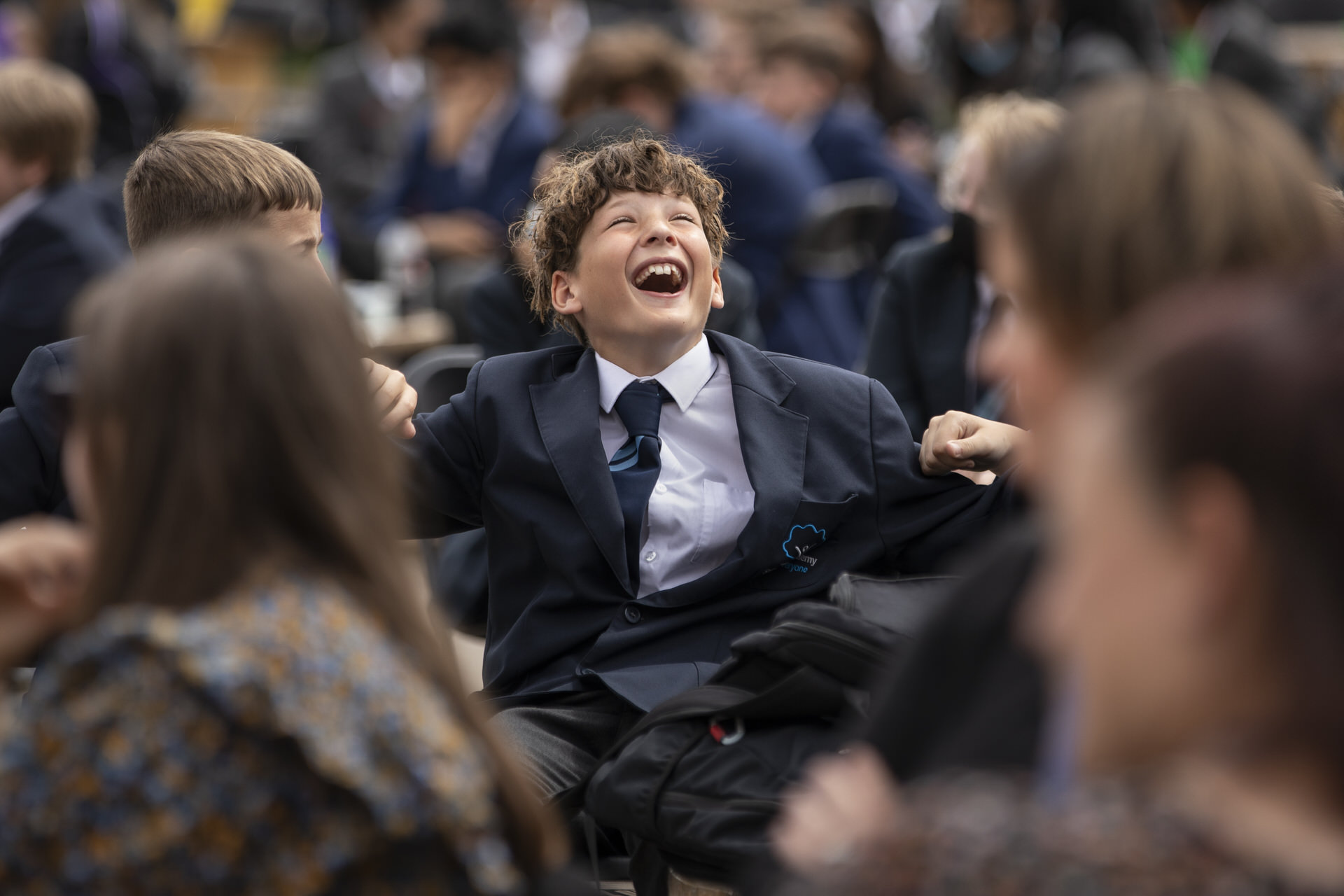 Young child laughing with friends