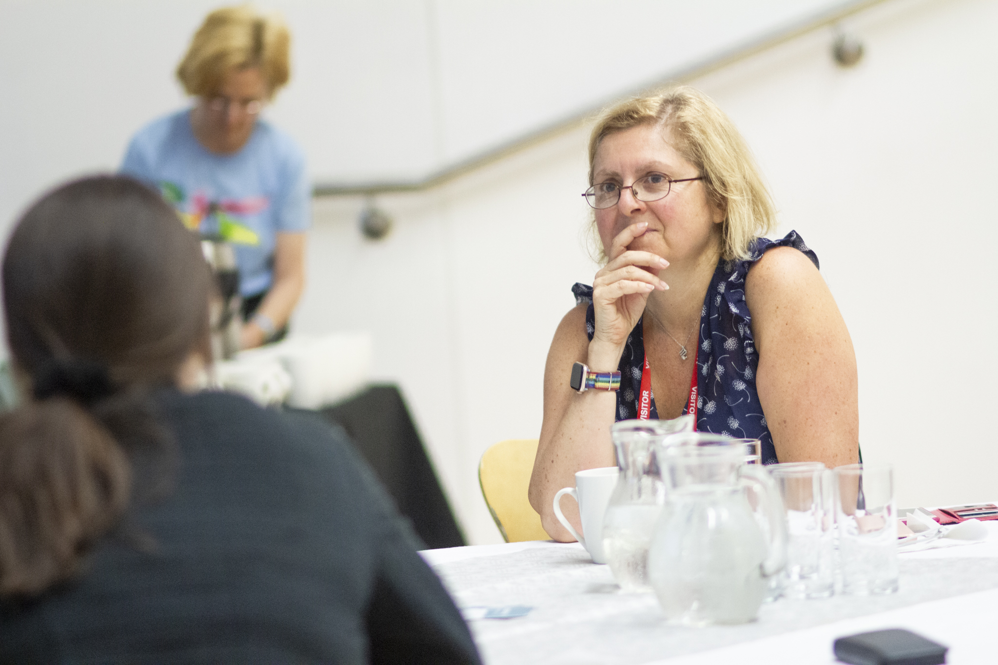 Adult participant having a table discussion with a colleague.