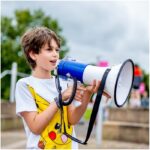 A child speaking into a megaphone